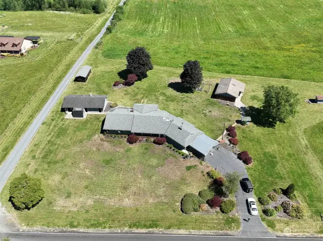 Sprawling Rambler, with detached shop to the left, behind that a machine/garden shed, to the right of that an indoor poolhouse!