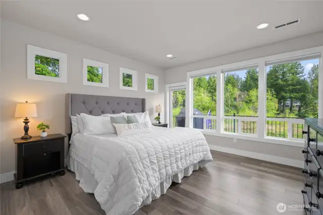 Wake up each day in the main floor primary suite looking out to your lake vistas.