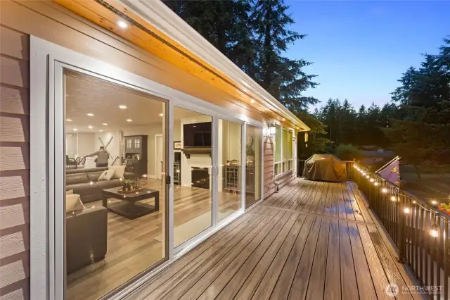 Great room opens to the deck overlooking the yard and lake.