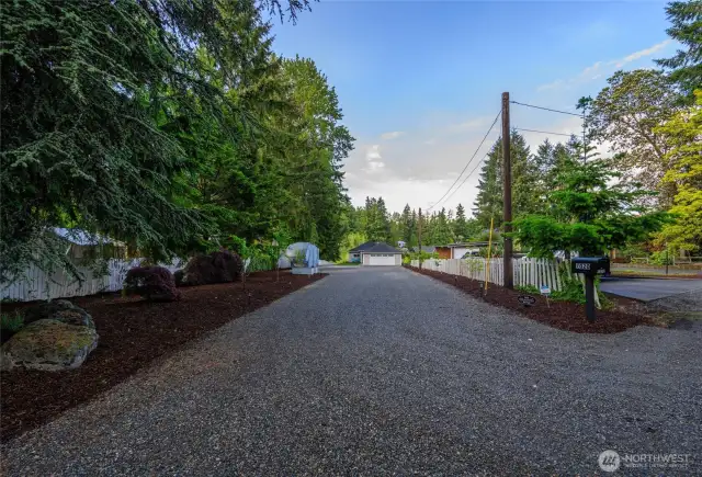 This just shy 1/2 acre lot has ample boat, RV AND vehicle parking, fruit trees & garden space too! The detached two car garage is wired for EV charger of choice. (EV charger not included).