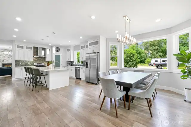 The dining area sits off the kitchen and looks out to the side yard.  Notice the modern lighting.