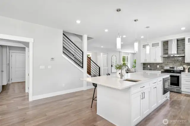 The kitchen island has a rinsing sink and a built in microwave. The laundry room is just off the kitchen to the left.
