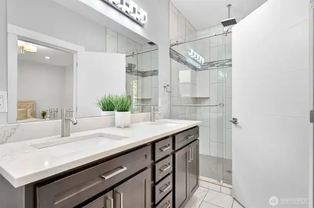 The private bathroom for the main floor bedroom has heated floors and an easy walk in shower.