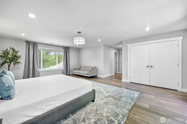 The primary upstairs is very spacious with room for a king sized bed and a sitting area.  The second closet is through the double doors.