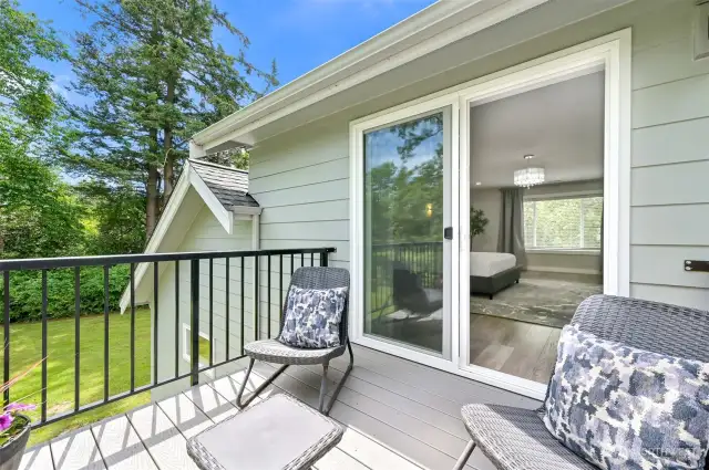 The upstairs primary suite has it's own deck looking out to the property.