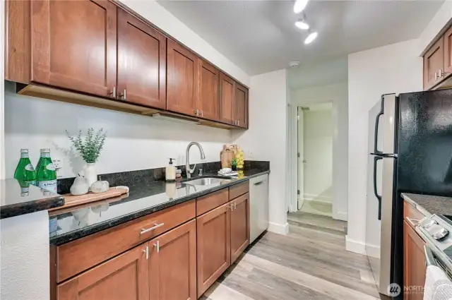 Kitchen features gorgeous cherry cabinets and granite countertops.