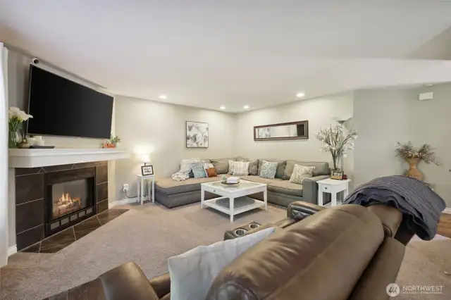 Another view of living room. To the right is the main entrance, hallway to 1/2 bath, Laundry room and Stairway to upstairs bedrooms.