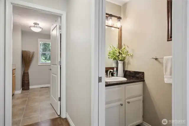 1/2 bath on main with slate tile, refinished cabinetry, upgraded lights and hardware and granite countertops.