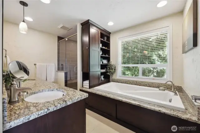 5 Piece primary ensuite with custom soft close cabinetry, dual sinks, a jetted tub, walk-in shower with 2 shower niches and a shower bench.