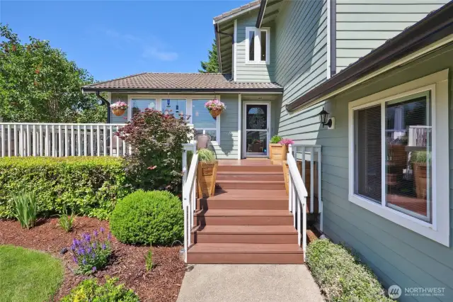 Step up to your front porch and wrap-around deck. Find views of the mountain here on a clear day.