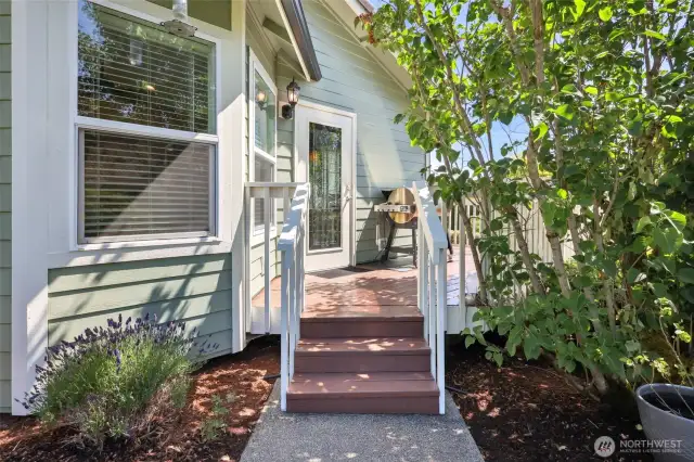 Side door that exits the dining/kitchen area. An excellent way to entertain. Show here is space for your BBQ/Pellet grill. Stairs lead to the side yard.