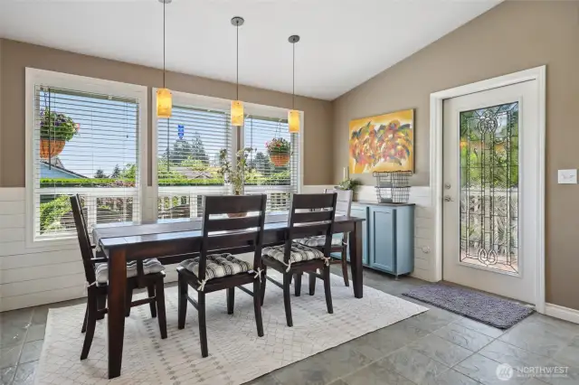 Open concept dining space with fun pendent lights. Catch views of the mountain here as well. Full light Codel door was added years ago and adds additional light to the already bright space.