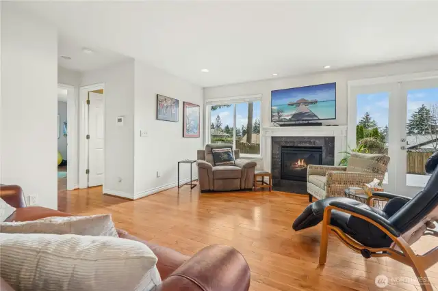 Living room open to the kitchen with french doors to backyard