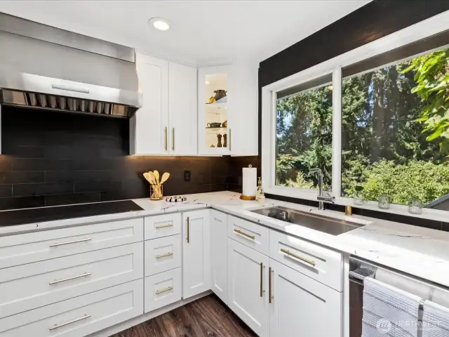 Gourmet kitchen features luxury Thermador appliances: double wall oven, 5-burner induction cooktop, refrigerator & dishwasher