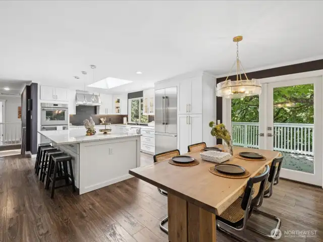 From near living room / fireplace looking across the home towards kitchen, open floorplan lives large & lends itself to amazing entertainment opportunities full of natural light