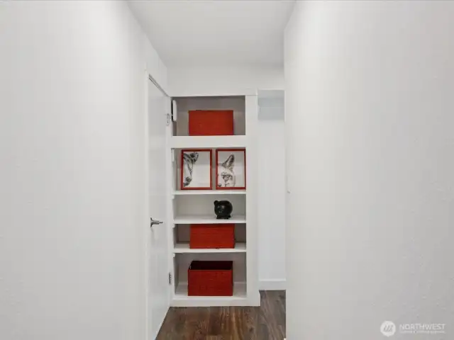 More built in storage to the left of stair landing, doorway to garage is just to the left