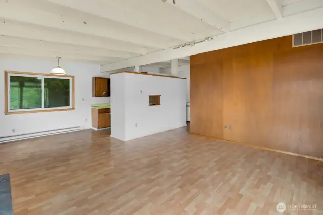 Another view of the living room, showing the wood accent wall adjacent to the front door.