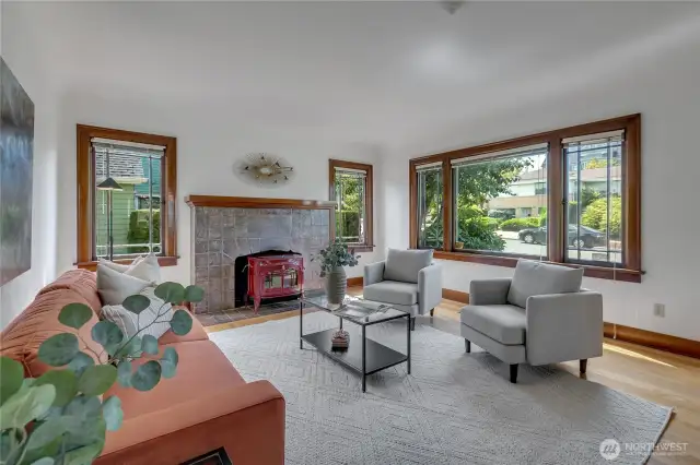 Large living room with all original quarter saw oak hardwood floors, mahogany trim, original tile fireplace & mantle, and nice tall coved ceilings!