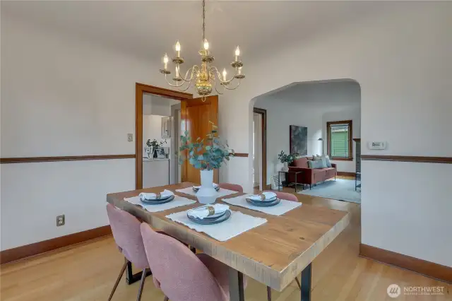 So many beautiful touches with the coved transition to the living room, swinging mahogany door to he kitchena nd a mahogany chair rail