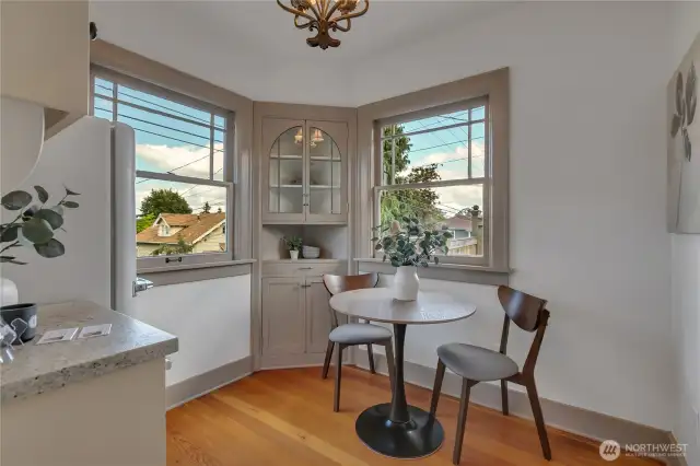 Sunny charming eating nook with built-in corner cabinet... notice the gleaming refinished Fir floors throughout a lot of the home!