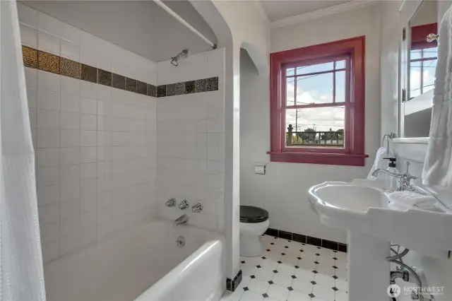 Update main floor full bathroom with tile shower surround and beautiful pedestal sink!