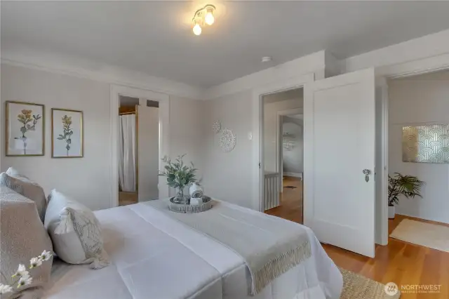 Primary bedroom with view to hall and primary bath