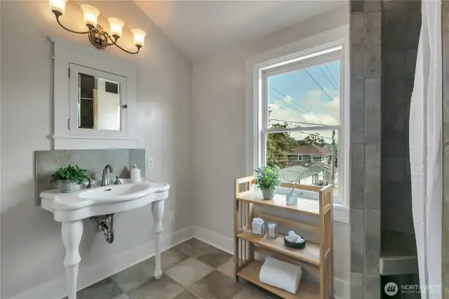 Gorgeous primary bath added with cathedral ceilings, walk in tile shower, heated ceramic tile flooring and this incredible vintage bathroom sink!