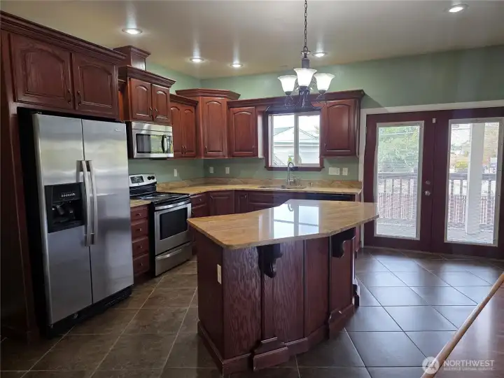 Large Granite island great for eating space or social hour! French Door access to patio & yard.