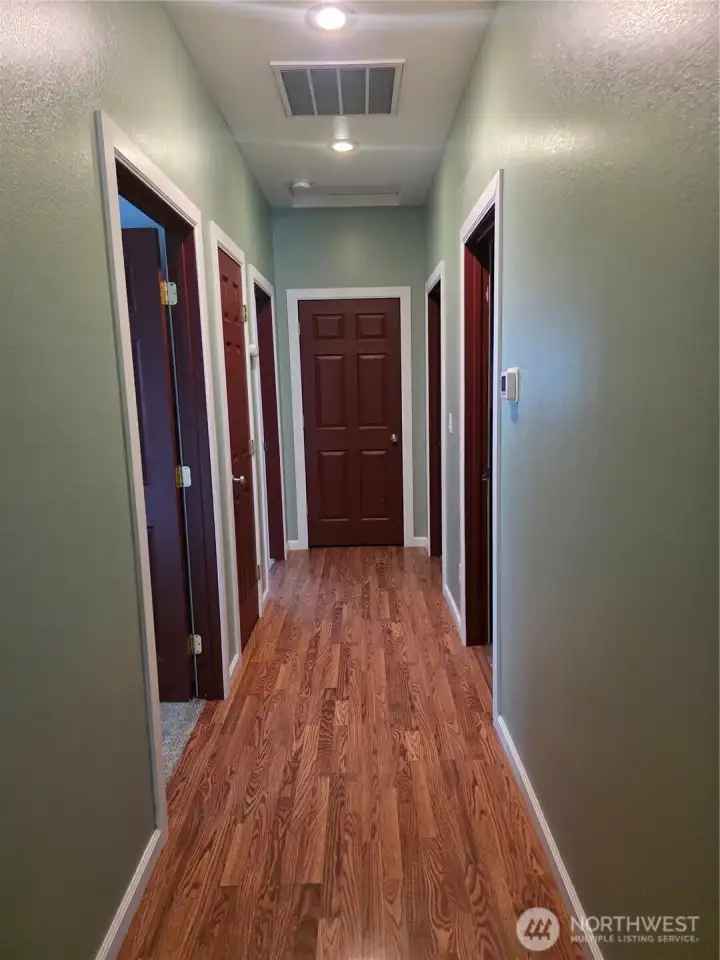 Hallway to bedrooms features plenty of closet space