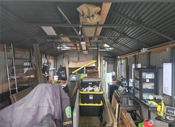 Inside the large shed with storage in the rafters.