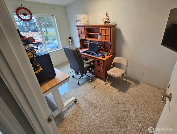 The 3rd bedroom is currently being used for an office.