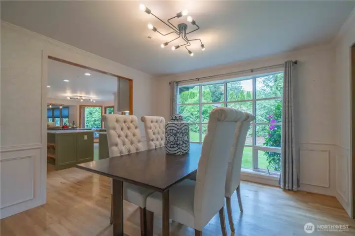 Spacious dining room with French doors to the pathway to the pergola and firepit.