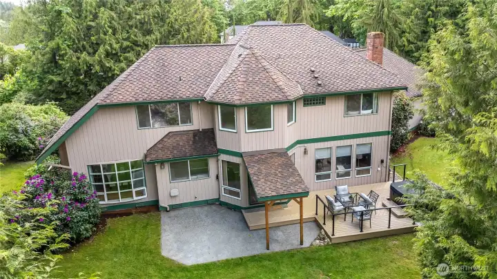 View of the back of the home. Plenty of room to entertain with the beautiful deck, hot tub, covered BBQ space and patio!