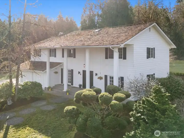 Classic exterior with timeless design, circular driveway, and mature landscaping creating a strong first impression.