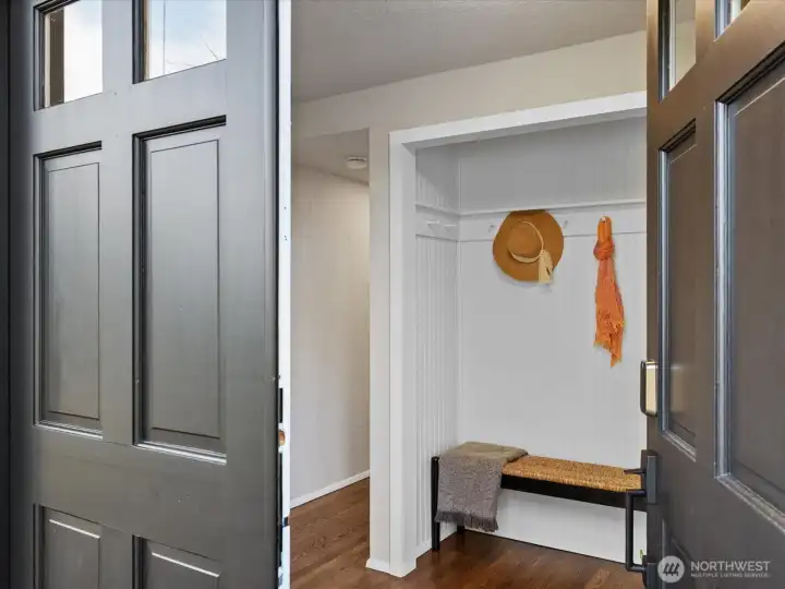 Inviting entry with nook for organizing coats and shoes.