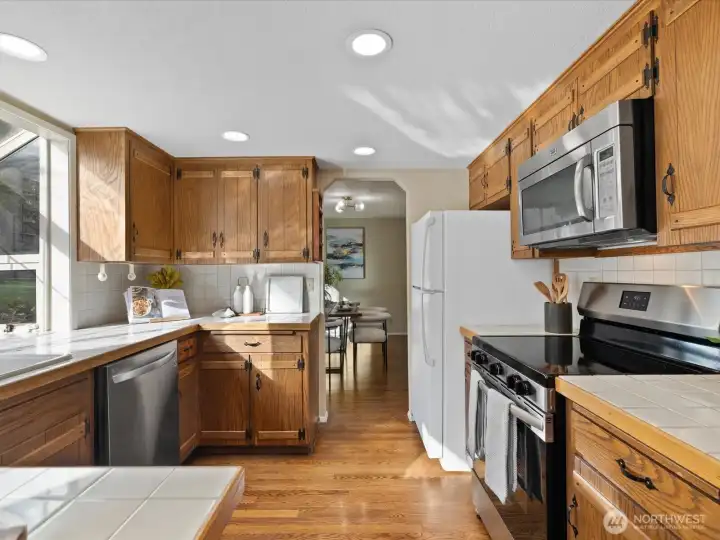 Well-maintained kitchen with plenty of counter space, storage, and a practical layout for cooking and gathering.