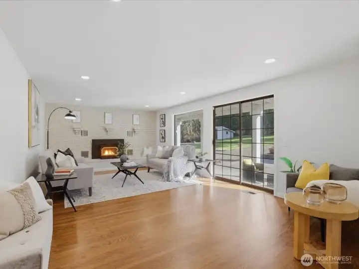 Cozy up by the fireplace in your second family/living room with direct access to the backyard/patio and garage.