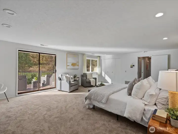Primary suite with direct outdoor access and large windows, bringing in natural light and backyard views.