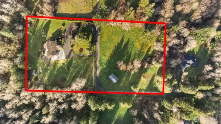 Aerial view of the 5-acre property showing open pasture, tree-lined boundaries, and overall layout