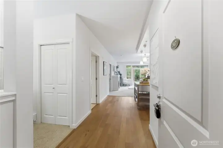 Welcoming entryway with the office/utility room just to the left and a sightline that carries all the way to the lush balcony outlook
