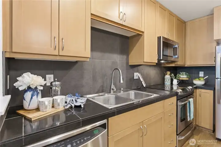 Close-up kitchen detail showcasing ample cabinetry, modern finishes, and stainless appliances with a clean prep area