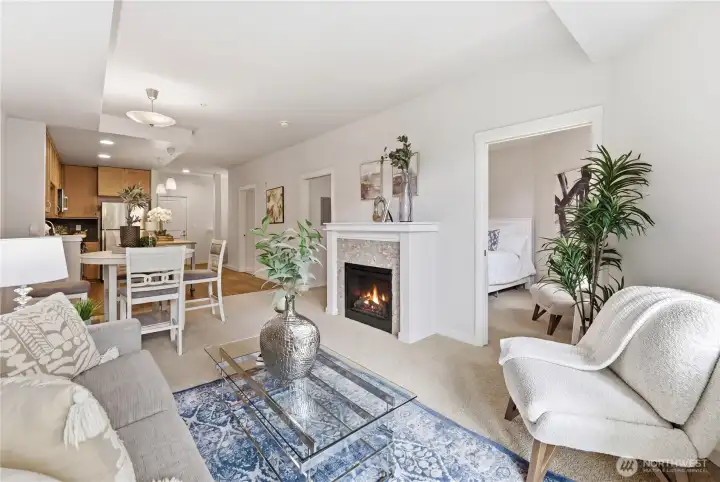 Warm, connected living spaces anchored by a glowing fireplace, flowing naturally from the living room to the dining area, kitchen, and bedroom