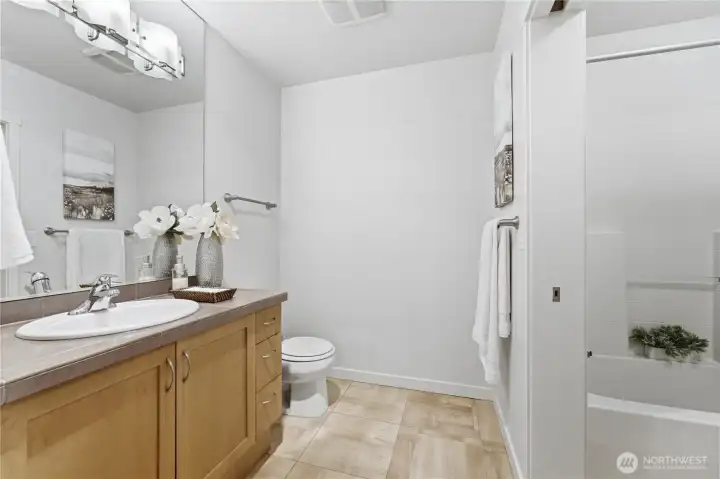 Bathroom with convenient dual entry — accessible from both the bedroom and the main living area for easy guest use