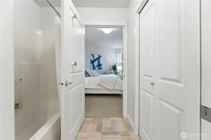 Bright hallway connecting the bathroom, storage, and the bedroom - an easy, intuitive layout