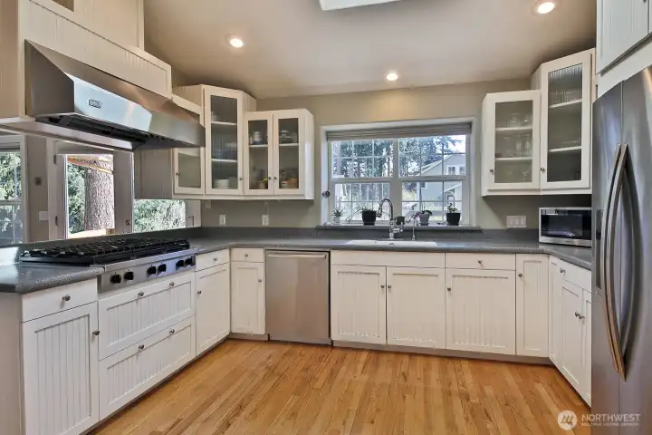 Spacious open Kitchen with six burner gas stove with plenty of cabinetry. The walk in pantry and Mudroom are to the photographer's back (pantry back left, mudroom back right). Kitchen sink window looks out upon your patio/east side of home. Spacious open Kitchen with six burner gas stove with plenty of cabinetry. The walk in pantry and Mudroom are to the photographer's back (pantry back left, mudroom back right). Kitchen sink window looks out upon your patio/east side of home.