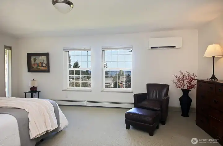 Spacious Primary Bedroom with a view of Saratoga Passage and Camano Island. Note the mini-spilt here. Your back is to the entrance of the bedroom and also to the walk-in closet. The bathroom is beyond the right edge of this photo. Spacious Primary Bedroom with a view of Saratoga Passage and Camano Island. Note the mini-spilt here. Your back is to the entrance of the bedroom and also to the walk-in closet. The bathroom is beyond the right edge of this photo.