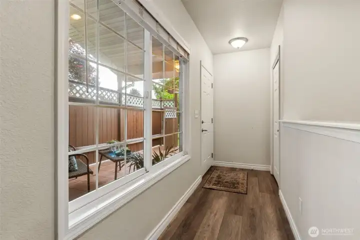The extra wide window at the front entry welcomes the outdoors, in and accents this welcoming, light-filled area with half-wall between entry and kitchen for an open, yet designated arrangement of space. The extra wide window at the front entry welcomes the outdoors, in and accents this welcoming, light-filled area with half-wall between entry and kitchen for an open, yet designated arrangement of space.