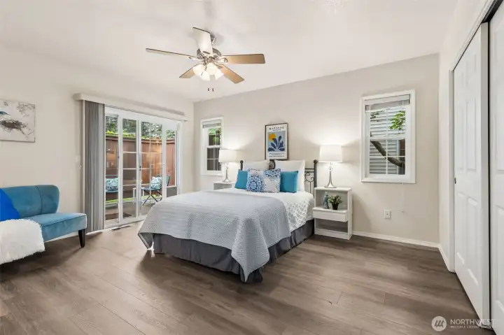 The primary suite offers allergy friendly wood-style laminate floors, a ceiling fan plus pretty sliding door access to the a private, western exposure patio retreat. The home backs to a green space for more privacy. The primary suite offers allergy friendly wood-style laminate floors, a ceiling fan plus pretty sliding door access to the a private, western exposure patio retreat. The home backs to a green space for more privacy.