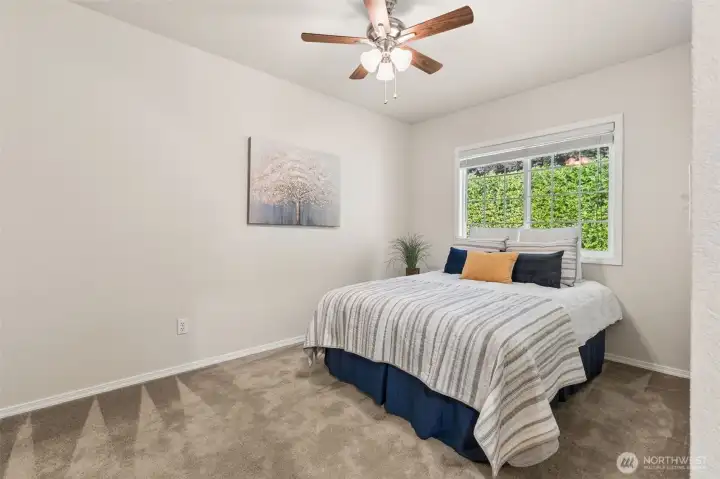 The large secondary bedroom leaves space for multiple uses and enjoys a view of the green belt. A cool and private space perfect for a guest bedroom or share that use with a desk or sewing corner. The large secondary bedroom leaves space for multiple uses and enjoys a view of the green belt. A cool and private space perfect for a guest bedroom or share that use with a desk or sewing corner.