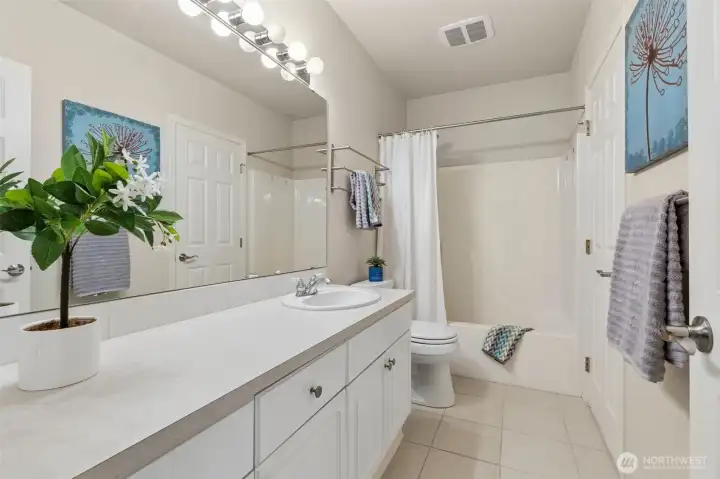 An extra long bathroom vanity waits for your grooming goodies! The secondary bathroom is accessed off the sleeping wing hallway, for daytime use, and from the second bedroom, offering private access. An extra long bathroom vanity waits for your grooming goodies! The secondary bathroom is accessed off the sleeping wing hallway, for daytime use, and from the second bedroom, offering private access.
